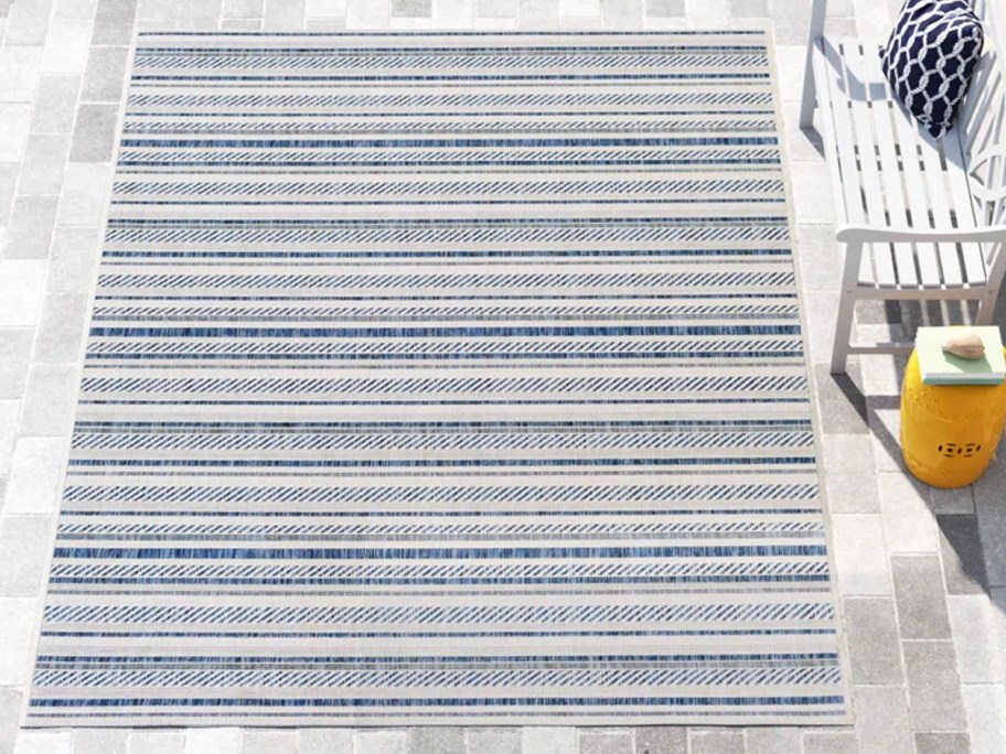 blue and white striped rug outdoors 