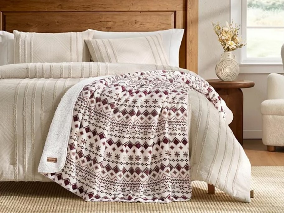 fair isle blanket on a bed with cream bedding