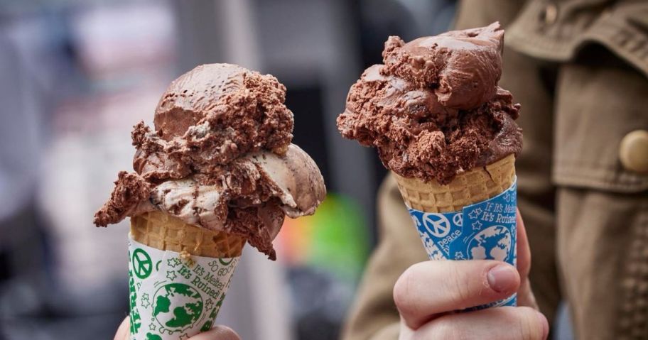 two hands holding ben & jerry's ice cream cones