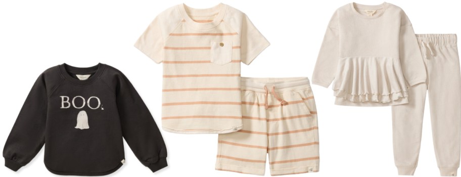 Burt's Bees Baby clothing items: a black crewneck sweatshirt with a white "BOO" graphic and a ghost, a cream and peach striped short-sleeve shirt and matching shorts set, and a cream-colored ruffle-hem long-sleeve top and pants set.