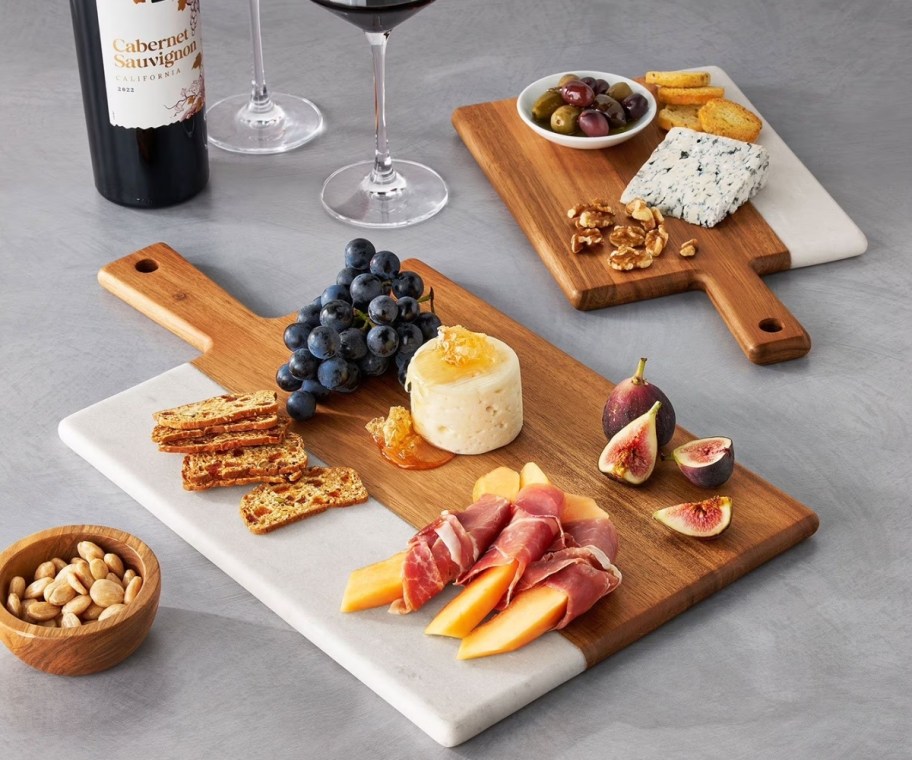 two members mark wood and marble charcuterie boards
