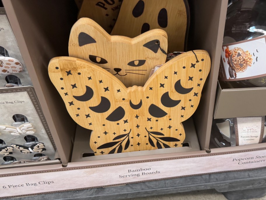 butterfly and cat cutting boards on shelf