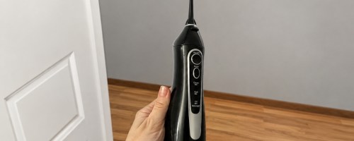 holding a black water flosser
