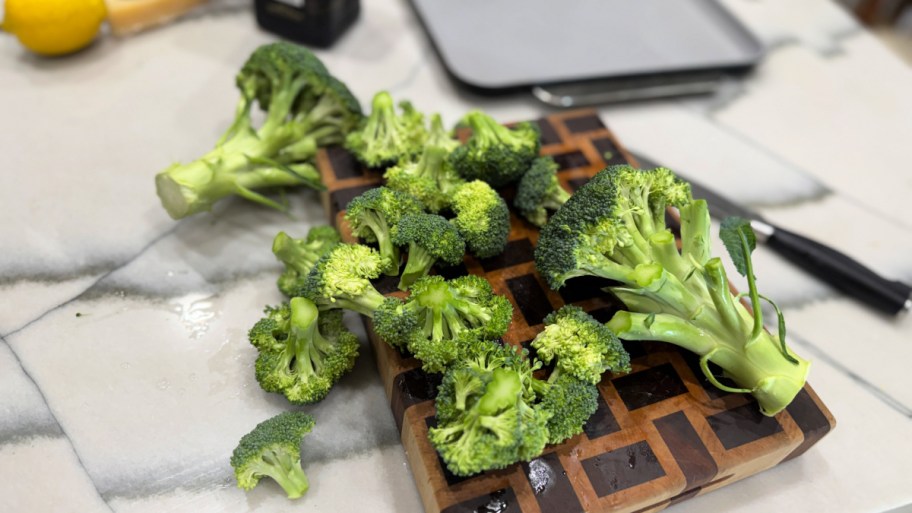 cutting up broccoli on a cutting board