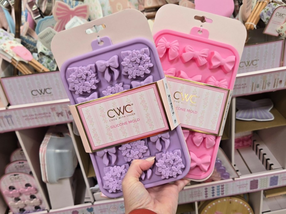 hand holding silicone floral or bow ice molds 