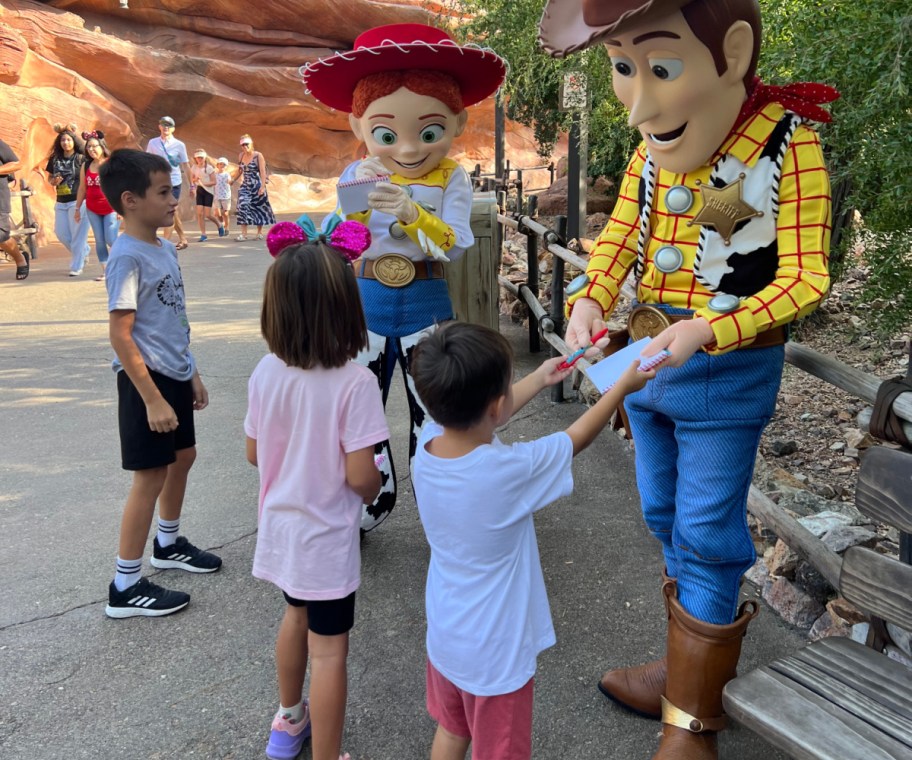 kids standing next to woody