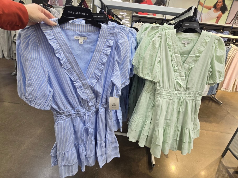 taking blue dress off Walmart clothing rack