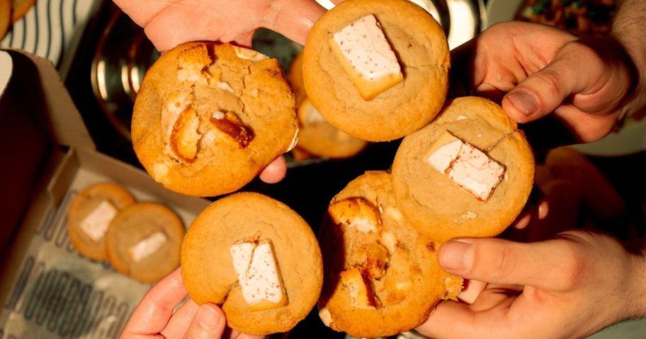 hands holding insomnia cookies Cloud 9 Cravings and strawberry toastie cookies