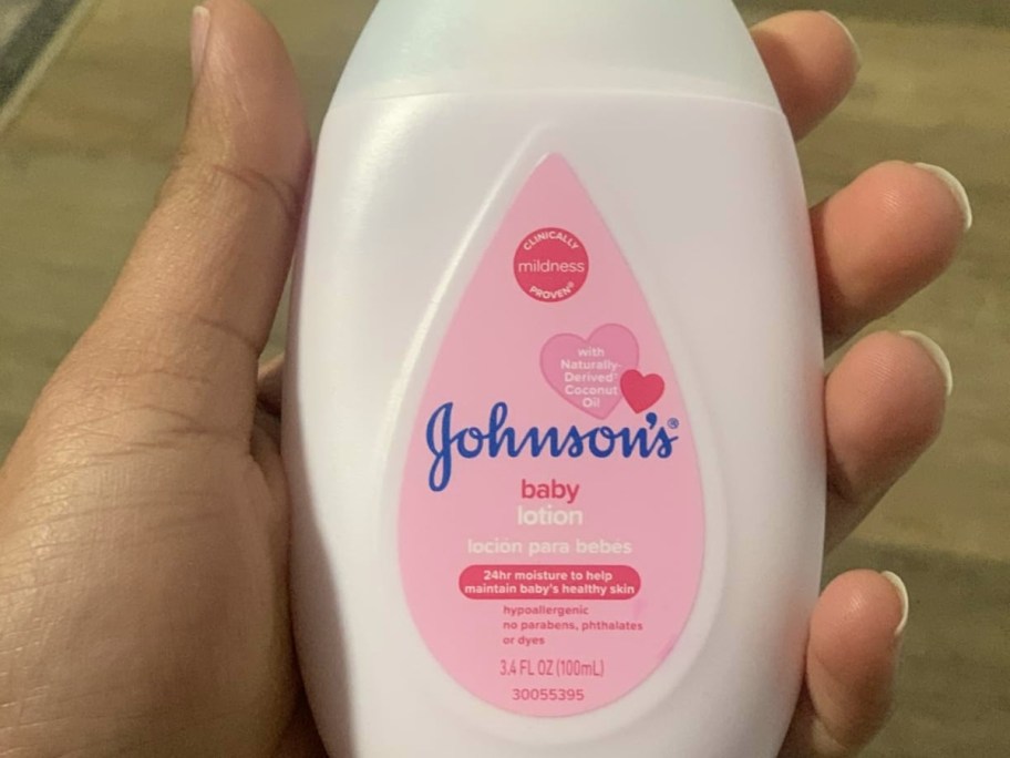 holding a bottle of Johnson's baby lotion