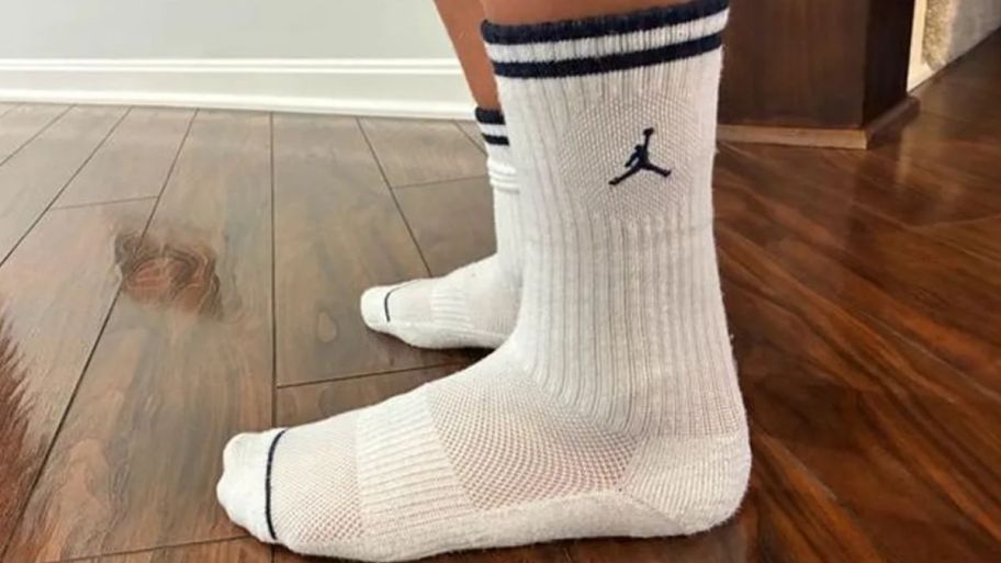 Person wearing jordan socks on wooden floors