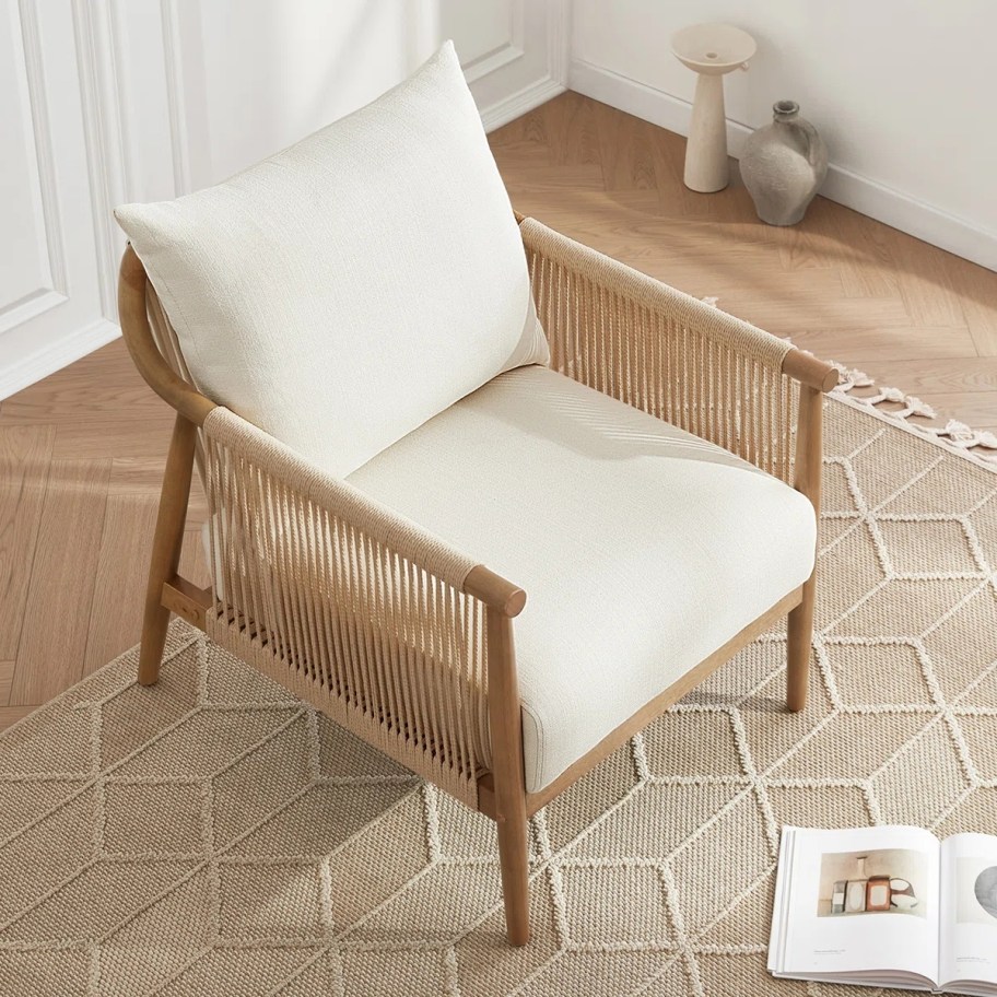 a wood frame chair with ivory coushion