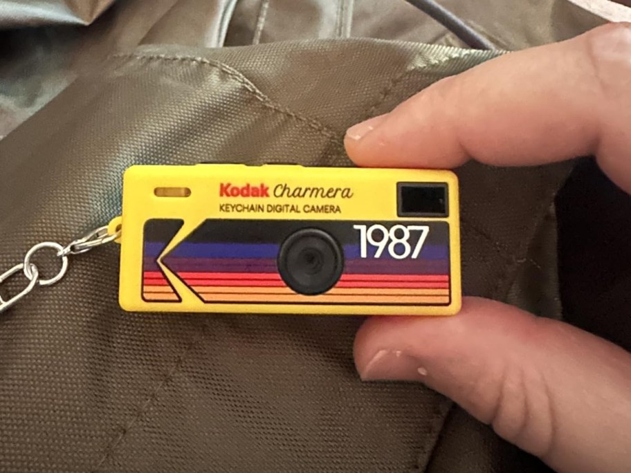 holding a camera keychain