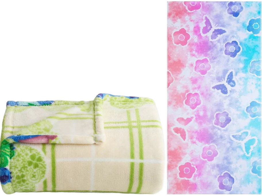 Folded beige blanket with green plaid and floral pattern on the left, and a towel with colorful pink, blue, and purple butterfly and flower design on the right.