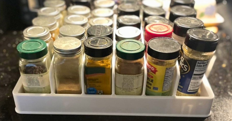 a kitchen cabinet organizer with spice jars