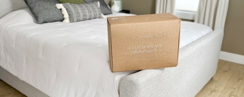 white comforter on bed with box