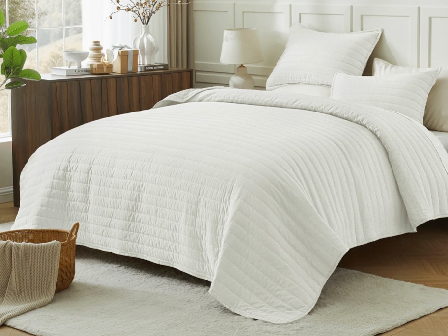 white quilt set on bed