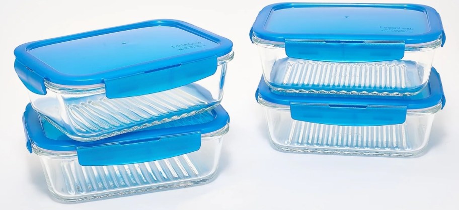 a four piece glass food storage set with blue lids