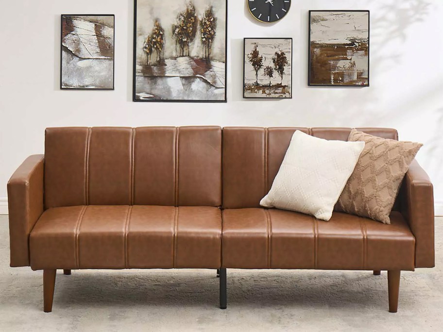 brown couch with pillows 