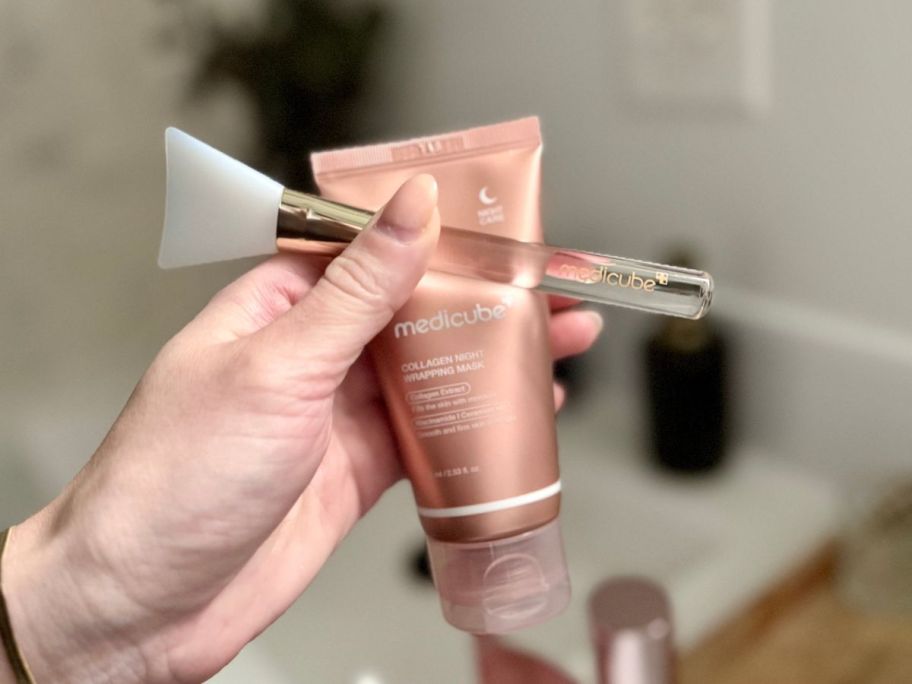 medicube Collagen Night Wrapping Mask and brush in hand