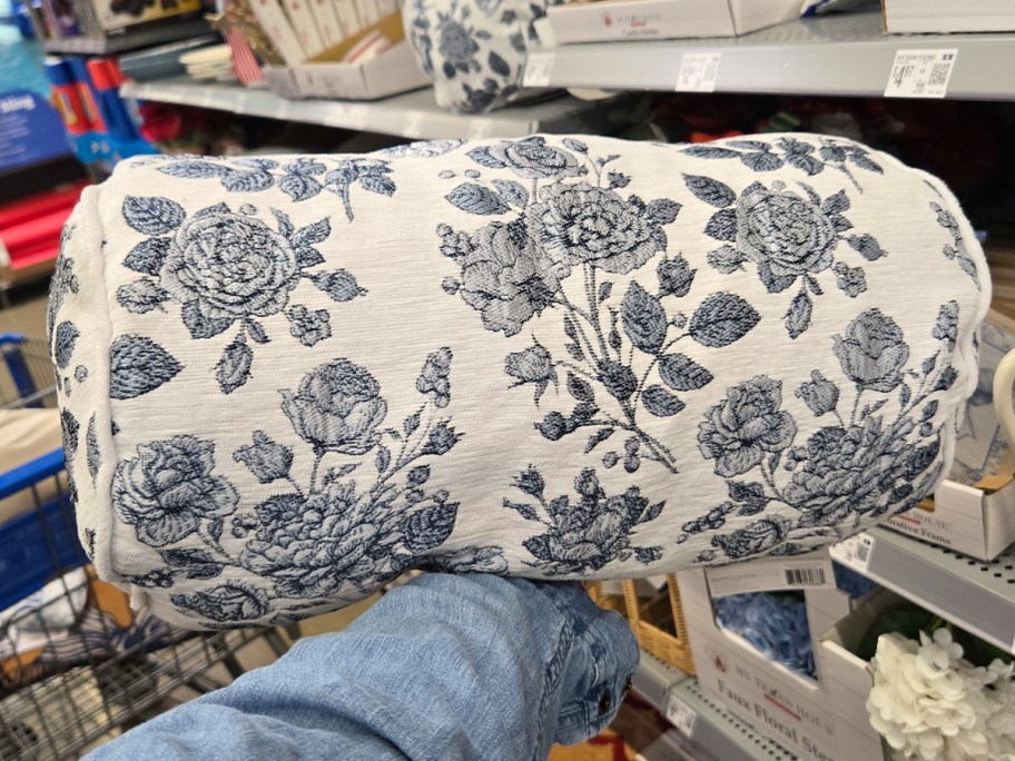 hand holding floral pillow 