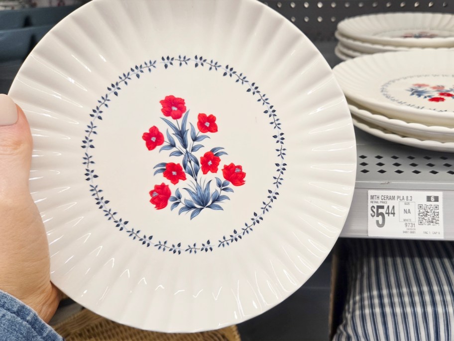 hand holding floral ceramic plate 