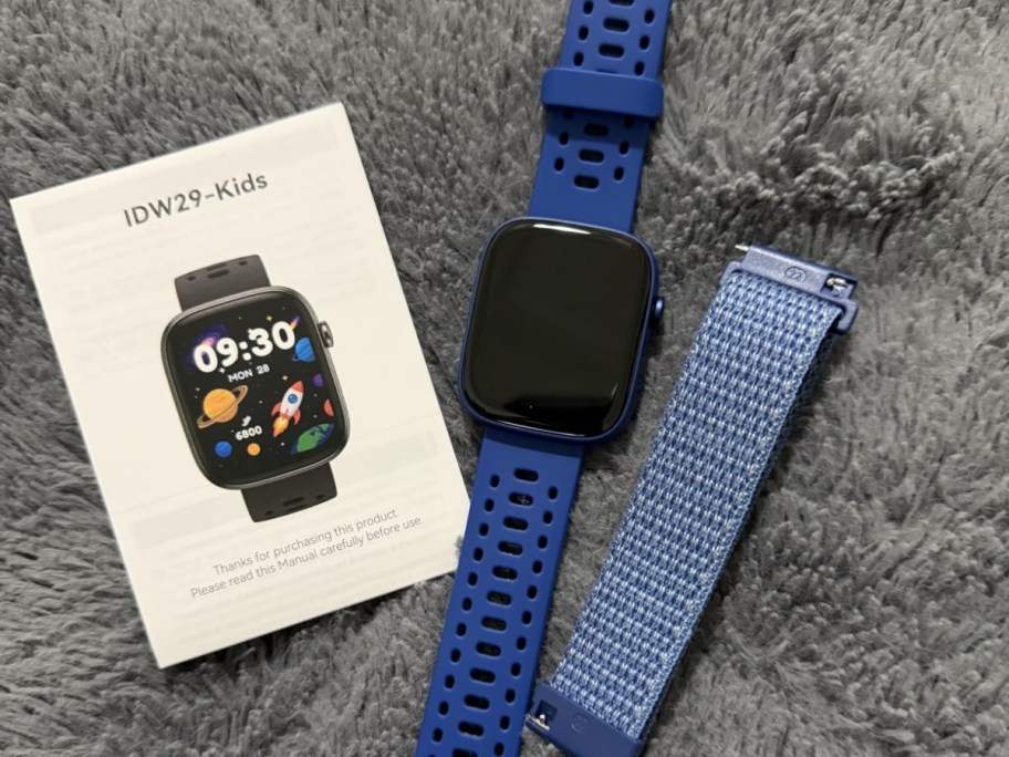 blue smartwatch next to instruction manual