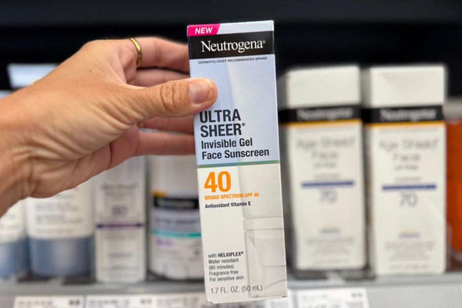 hand holding sunscreen in store