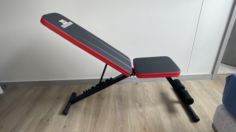 weight bench in a room with a hardwood floor