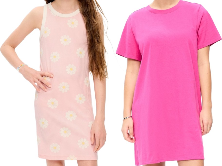 Two women stand side by side. The left wears a sleeveless pink dress with daisy patterns, while the right wears a solid bright pink T-shirt dress.