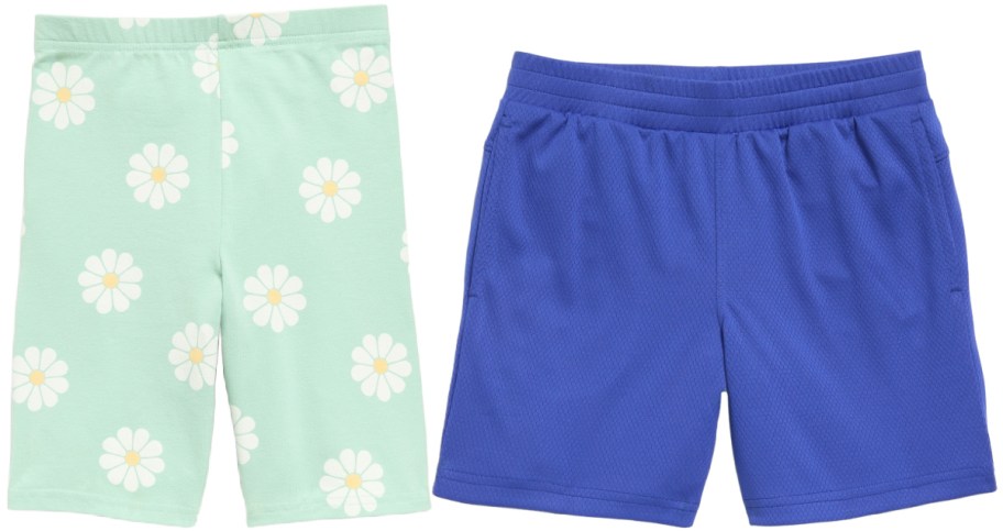 Two pairs of shorts side by side: mint green shorts with white daisy pattern on the left, and solid royal blue athletic shorts on the right.