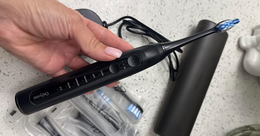 hand holding electric toothbrush