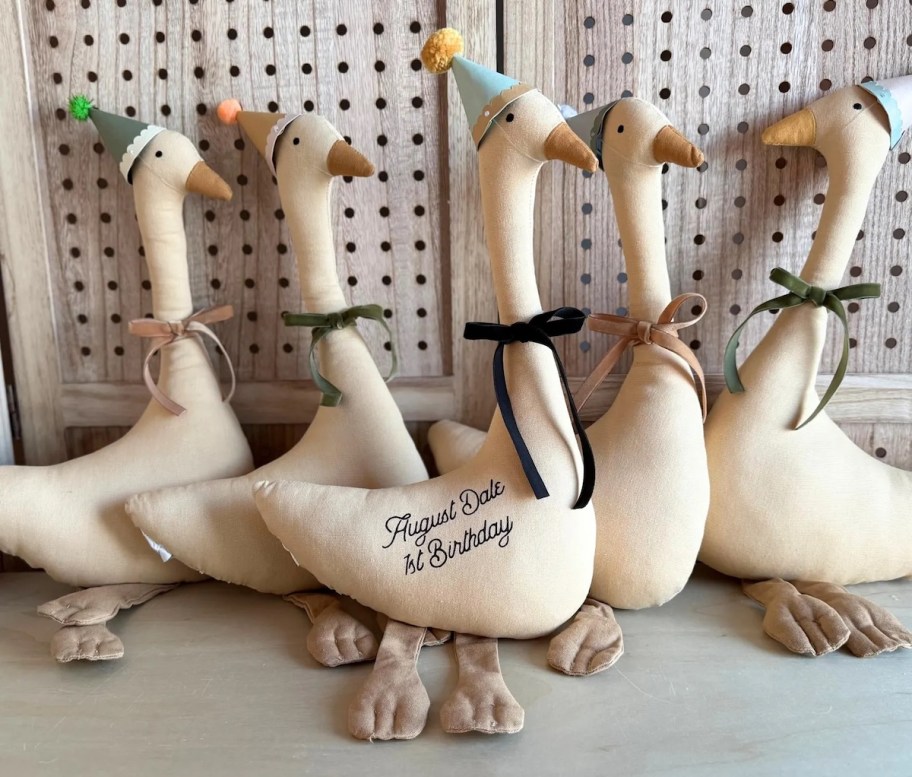 stuffed birthday goose lined up in front of cabinet