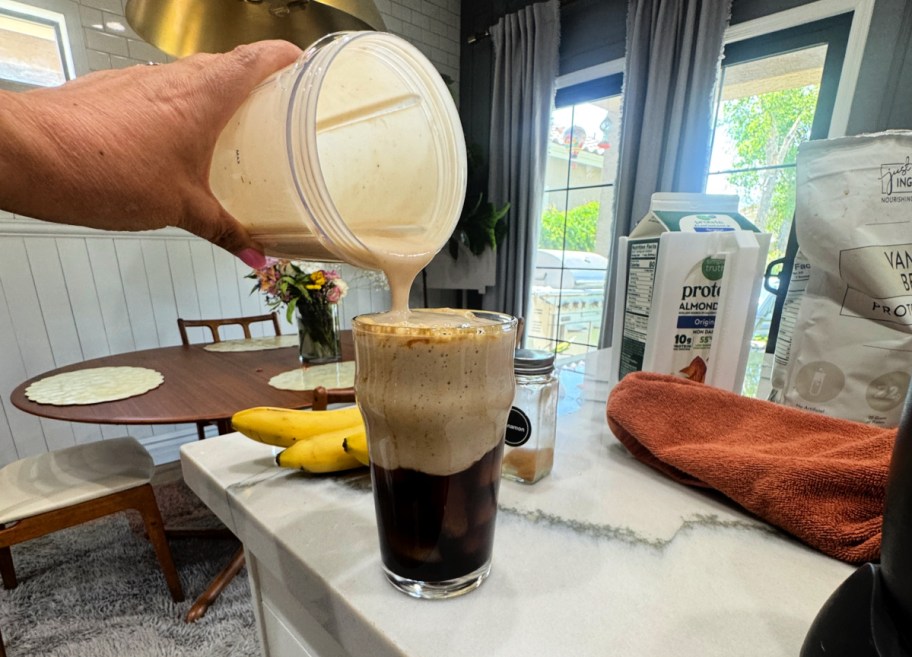 pouring a banana milk latte 