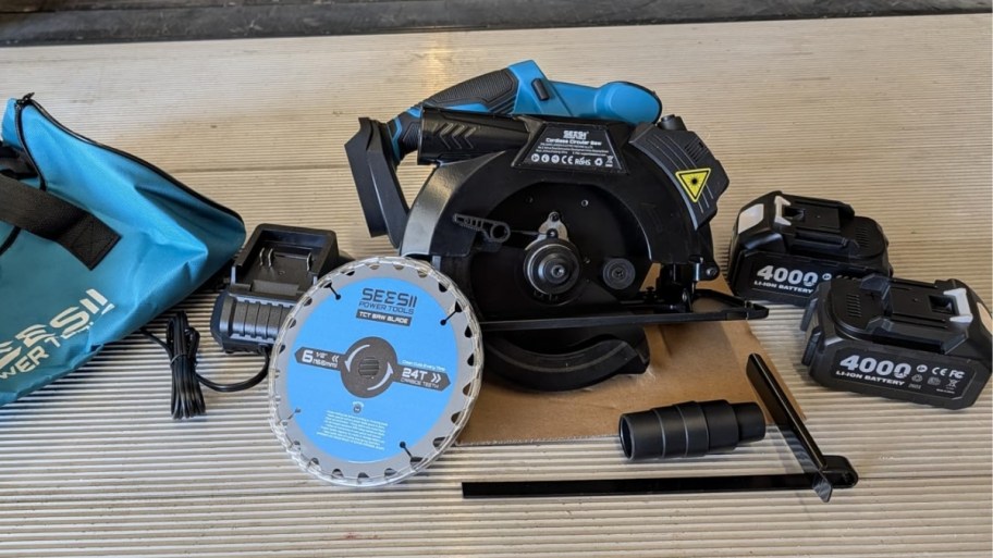 a compact circular saw, blade, batteries and accessories