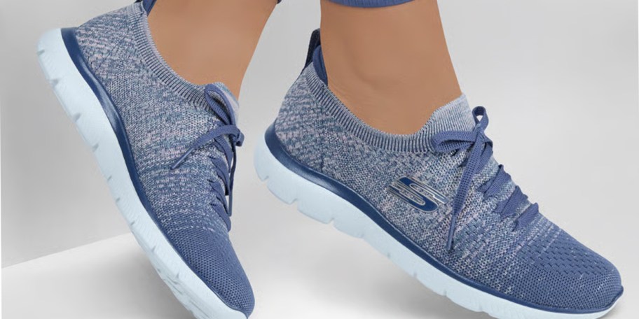 person wearing blue skechers shoes