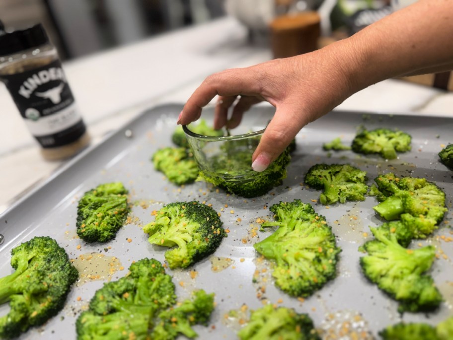 smashing broccoli with a small bowl 