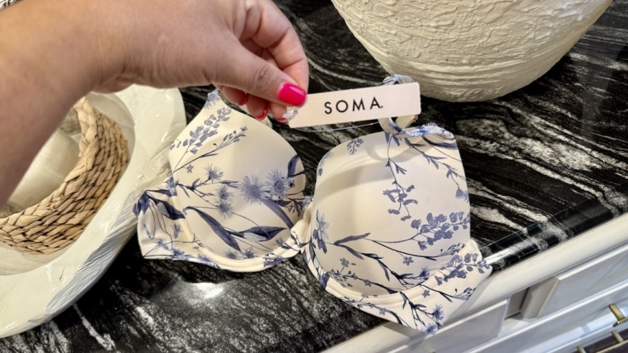 a woman reaching for the tag on a soma bra