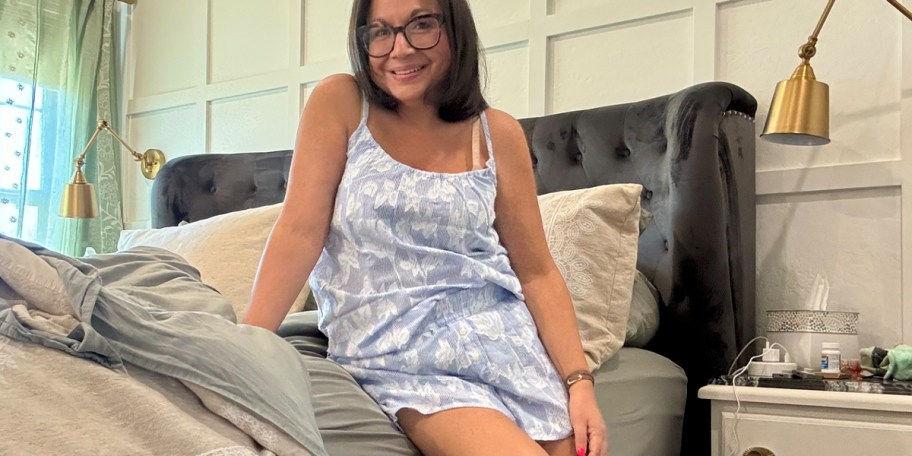 woman in blue and white pajamas on bed 