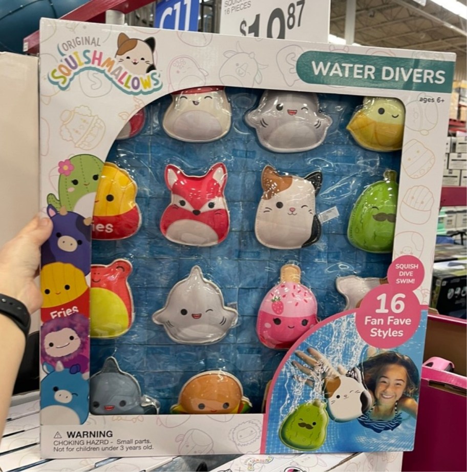 womans hand holding a squishmallows water divers set