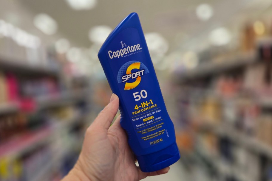 hand holding sunscreen in store