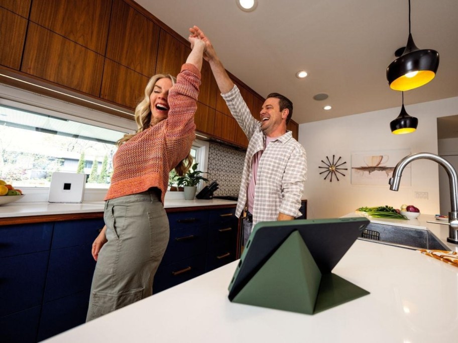woman and a man dancing in a kitchen