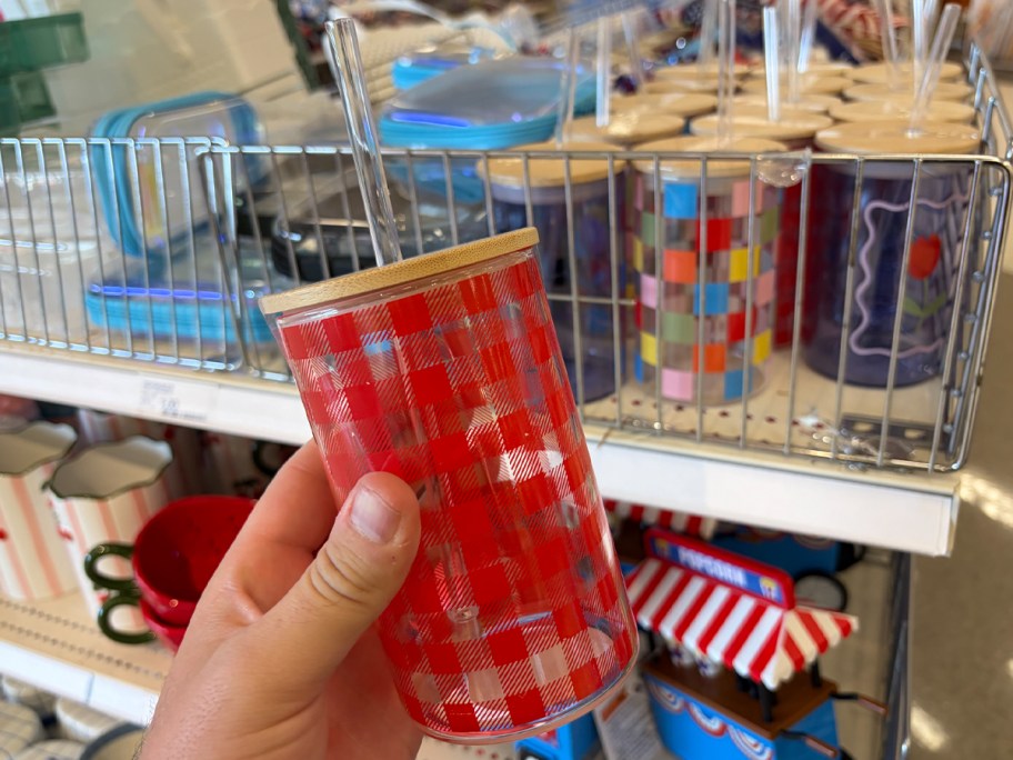 hand holding red gingham tumbler