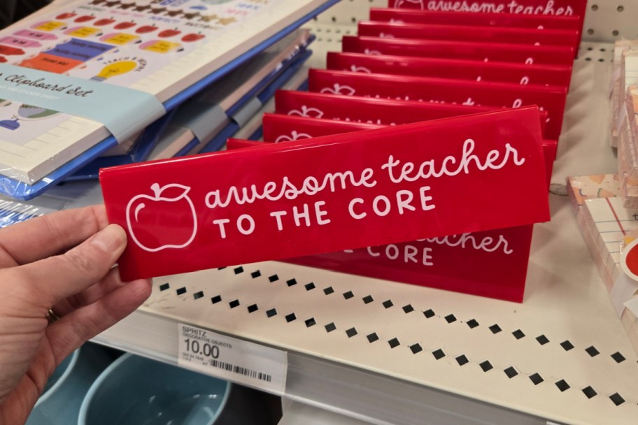 hand grabbing small red desk sign