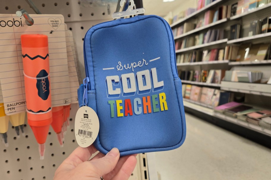 hand holding blue zip pouch in store