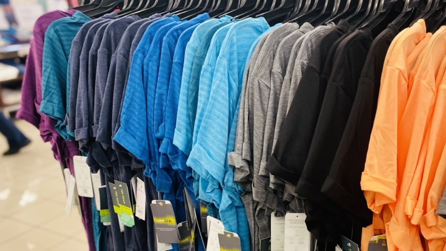 tek gear tees hanging on a rack in a store