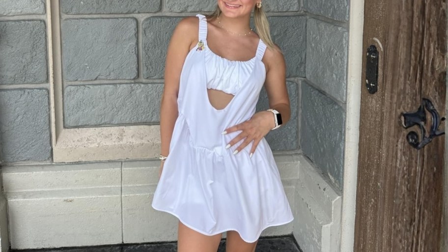 a woman in a white tennis dress and shorts set