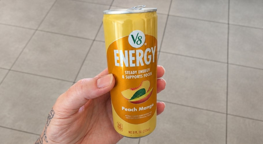 man holding a can of v8 energy drink