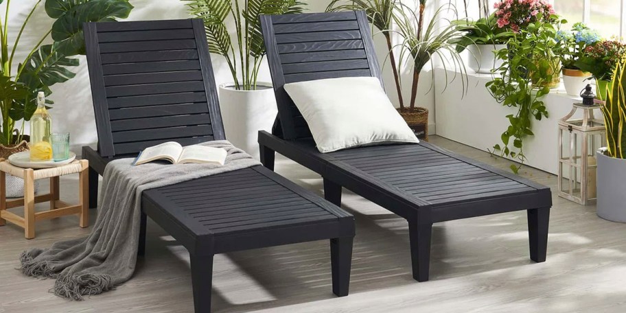 two black lounge chairs with white pillows