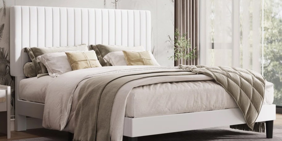 white bed with tan bedding 