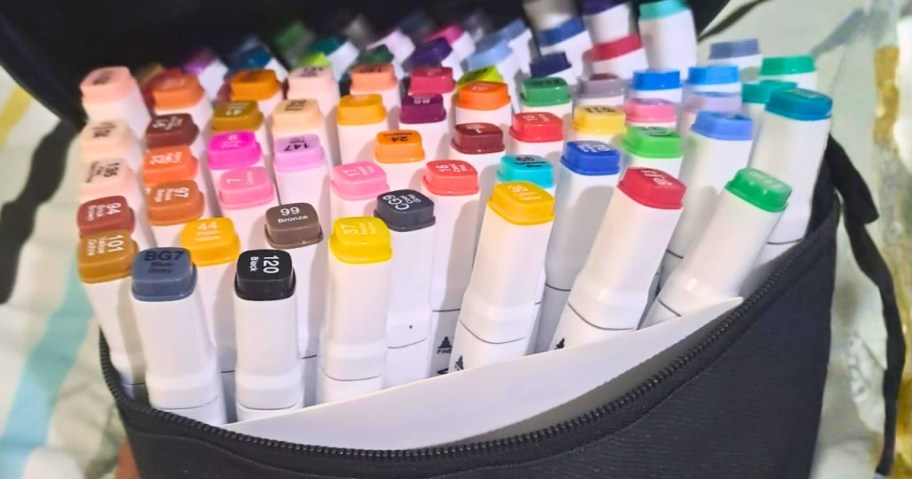 a bag of markers on a bed
